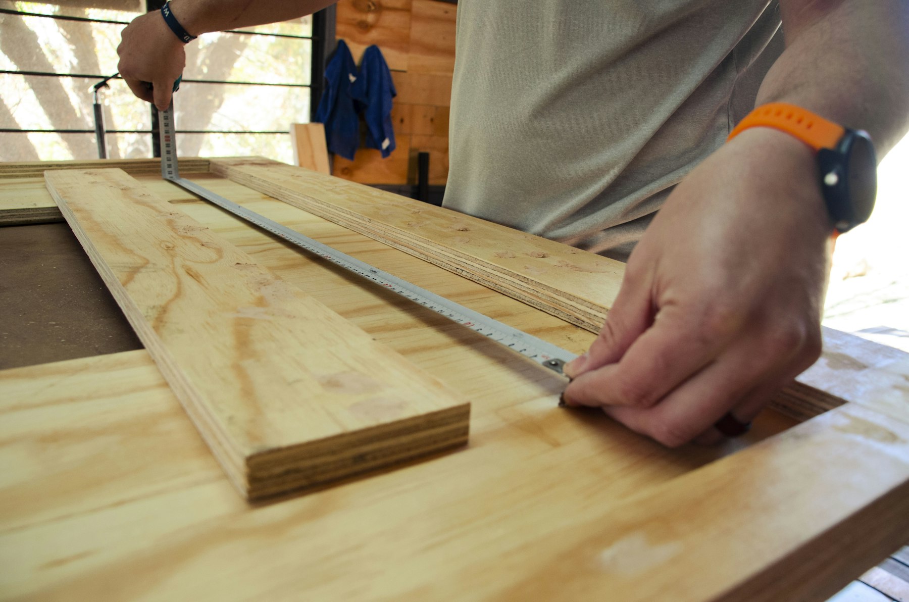 A maker checking a frame with a steel rule